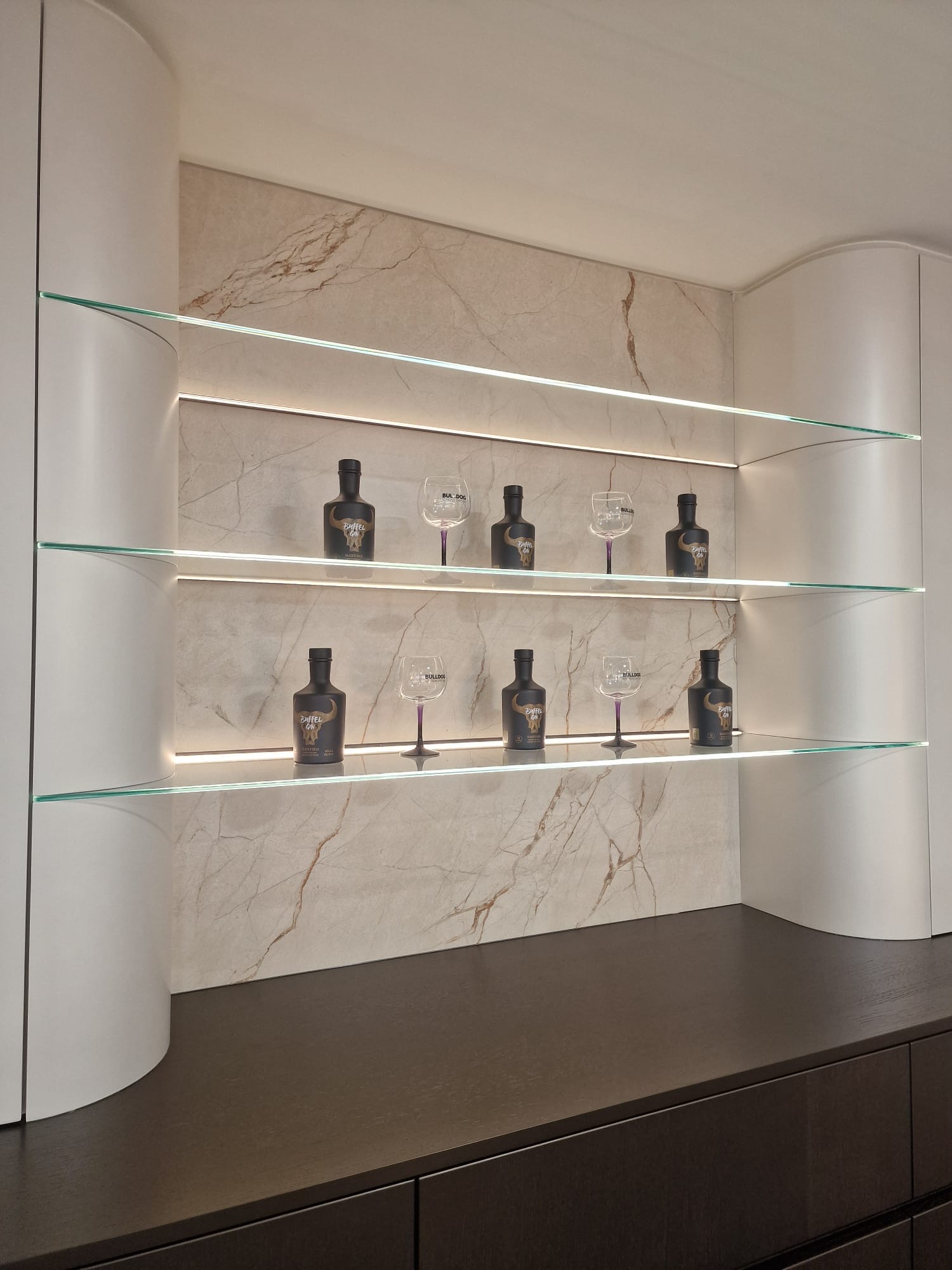 Home bar with porcelain slab backsplash and lighted glass shelves, slab fabrication project