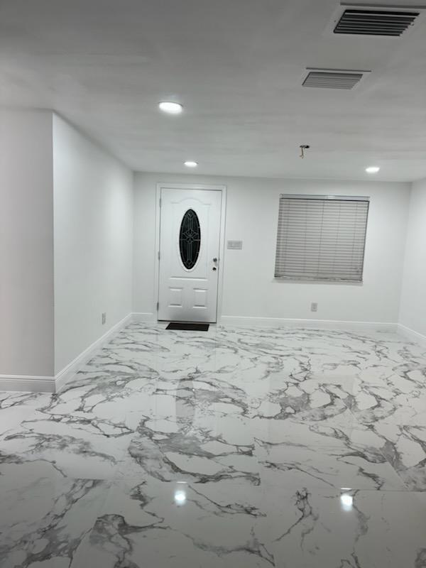 Finished glossy marble-look large-format porcelain tile floor, Tampa customer project