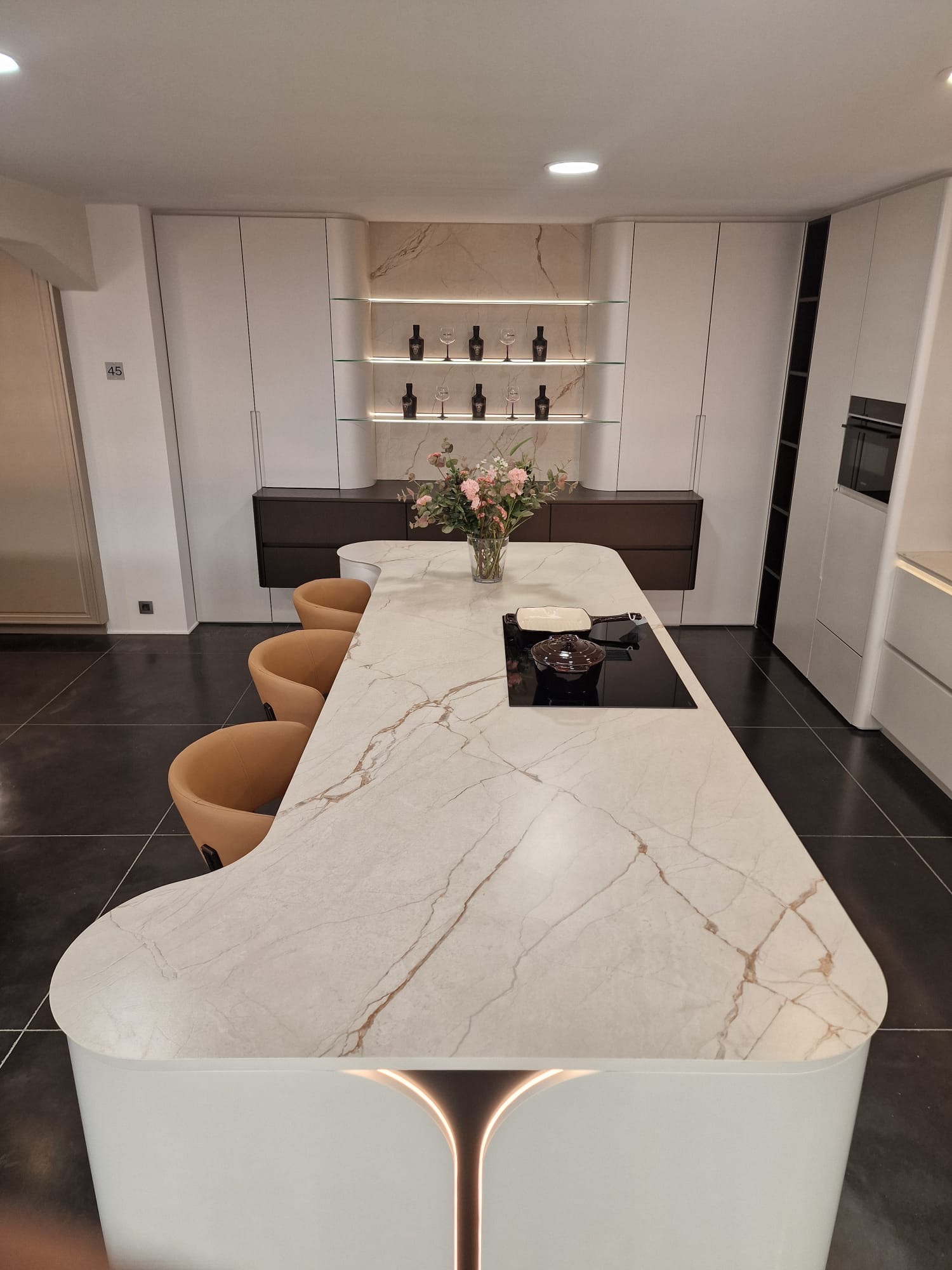 Marble-look porcelain slab kitchen island with gold veining, close-up