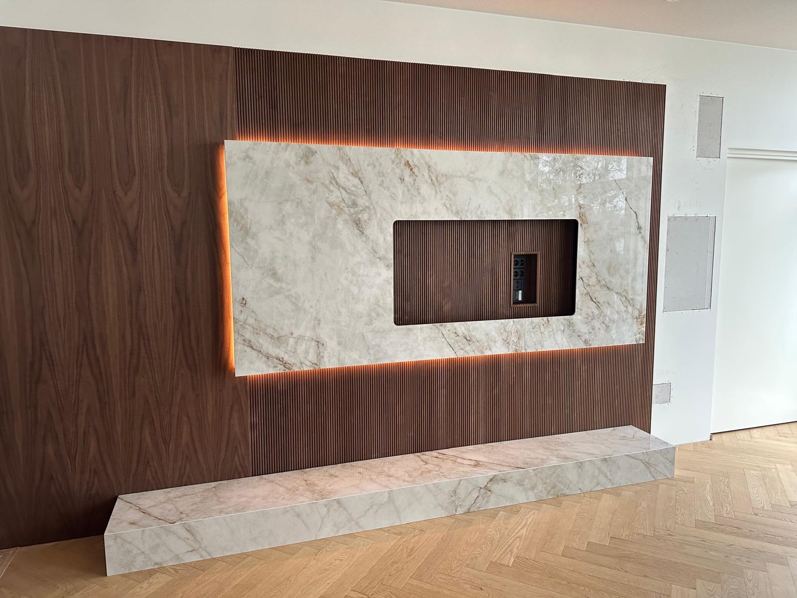 Backlit porcelain slab TV feature wall on walnut wood paneling